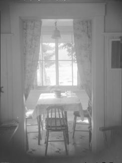 Untitled (table and chairs by a window)