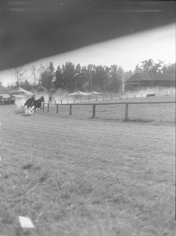Untitled (racetrack with horses and jockeys)