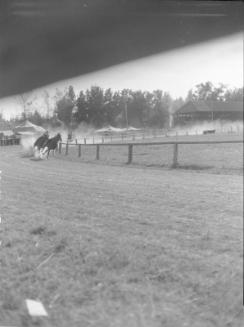 Untitled (racetrack with horses and jockeys)