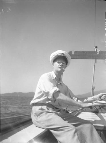 Untitled (L.G. Saunders at tiller of boat)