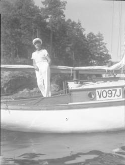 Untitled (man leaning on boom of sailboat)