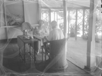 Untitled (couple dining by open patio)