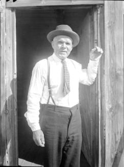 Untitled (man in doorway wearing suspenders)