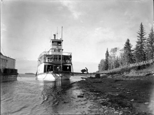 Untitled (docked paddle-boat being loaded)