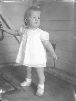 Untitled (baby in dress, standing)