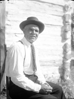Untitled (man seated wearing hat and suspenders)