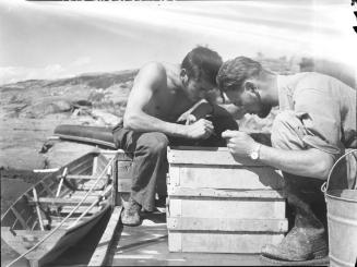 Untitled (men on wharf with crates)