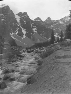 Untitled (cars by stream in mountains)