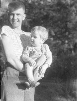 Untitled (boy holding baby)