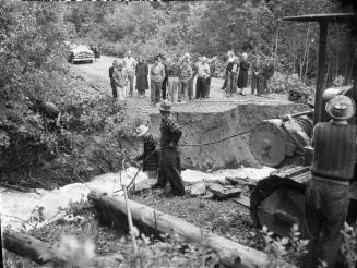Untitled (spectators at washed-out road)