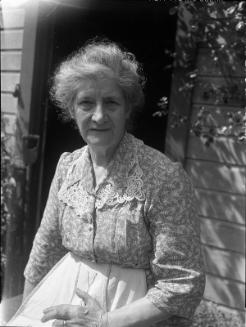 Untitled (elderly woman sitting by doorway)