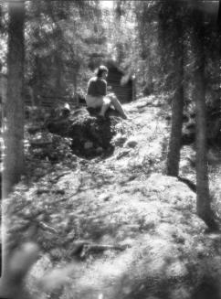 Untitled (woman near cabin)