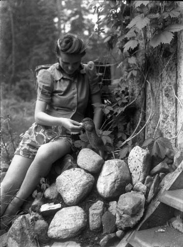 Untitled (young woman feeding gopher)
