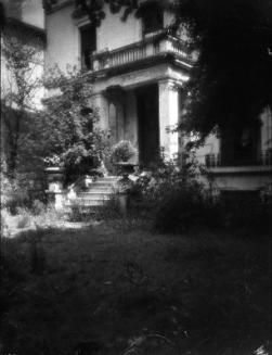 Untitled (large stone building with unkept yard)