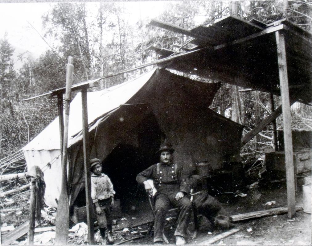 Henry & Bill in front of their first home in Thomson's Landing