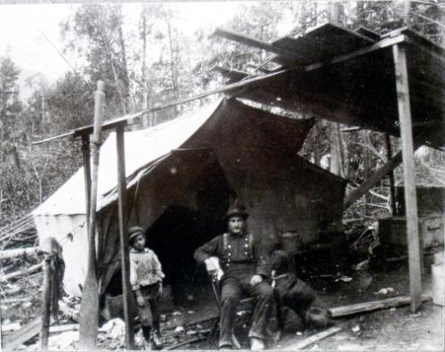 Henry & Bill in front of their first home in Thomson's Landing