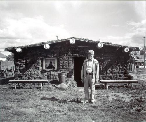 Eldon Pfeffer in Front of an Authentic Sod House, Elbow Museum, 1981