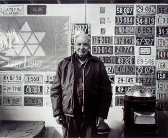 Milden Community Museum. Ronald R. Watt with the museum's license plate collection, 1981