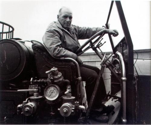 Regina Firefighters Museum. Wes Turner on a 1928 L. A. France fire engine awaiting restoration, 1981
