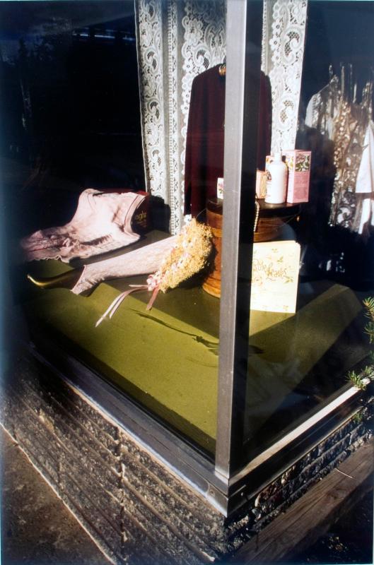 display window showing women's clothing, lotions, etc.