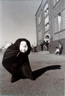 Gloria Neapetung in mask and body bag used for drama practice