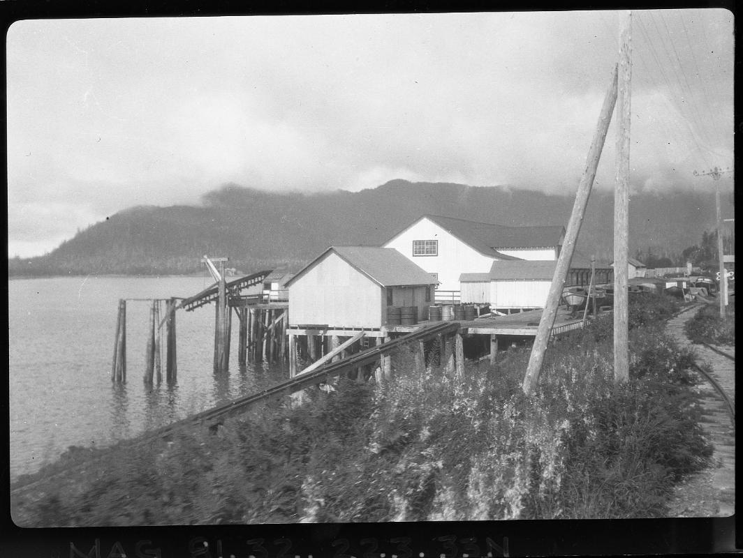 Untitled (buildings on stilts by lake and railway track)