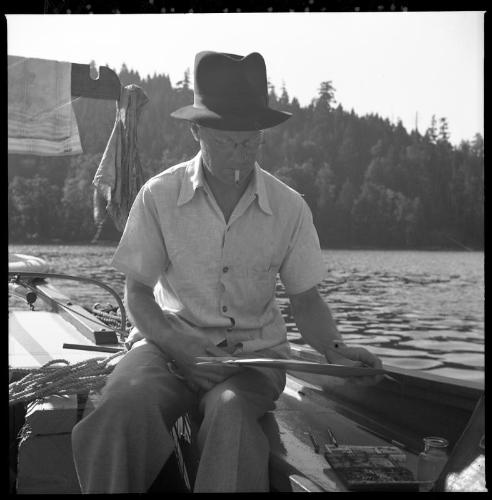 Untitled (L.G. Saunders painting on deck of boat)