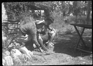 Untitled (two women feeding gopher)