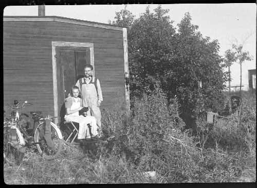 Untitled (man and young woman outside shed)