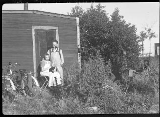 Untitled (man and young woman outside shed)