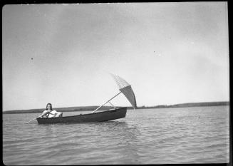 Untitled (woman in boat with sun umbrella)