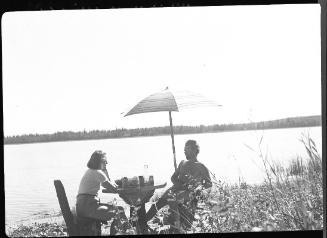 Untitled (man and woman under sun umbrella)