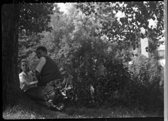 Untitled (couple behind tree)