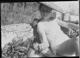 Untitled (semi-nude woman sunbathing)