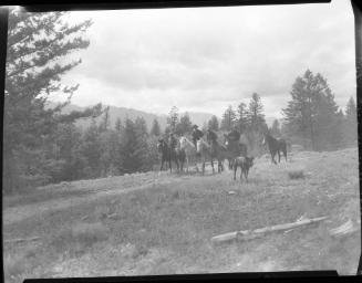 Untitled (men horseback riding through mountains)